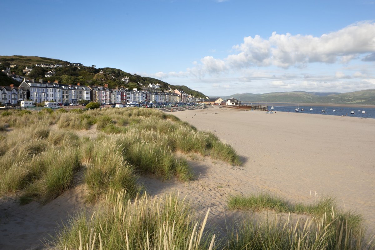 A view of the Aberdovey seafront and beach with some dunes